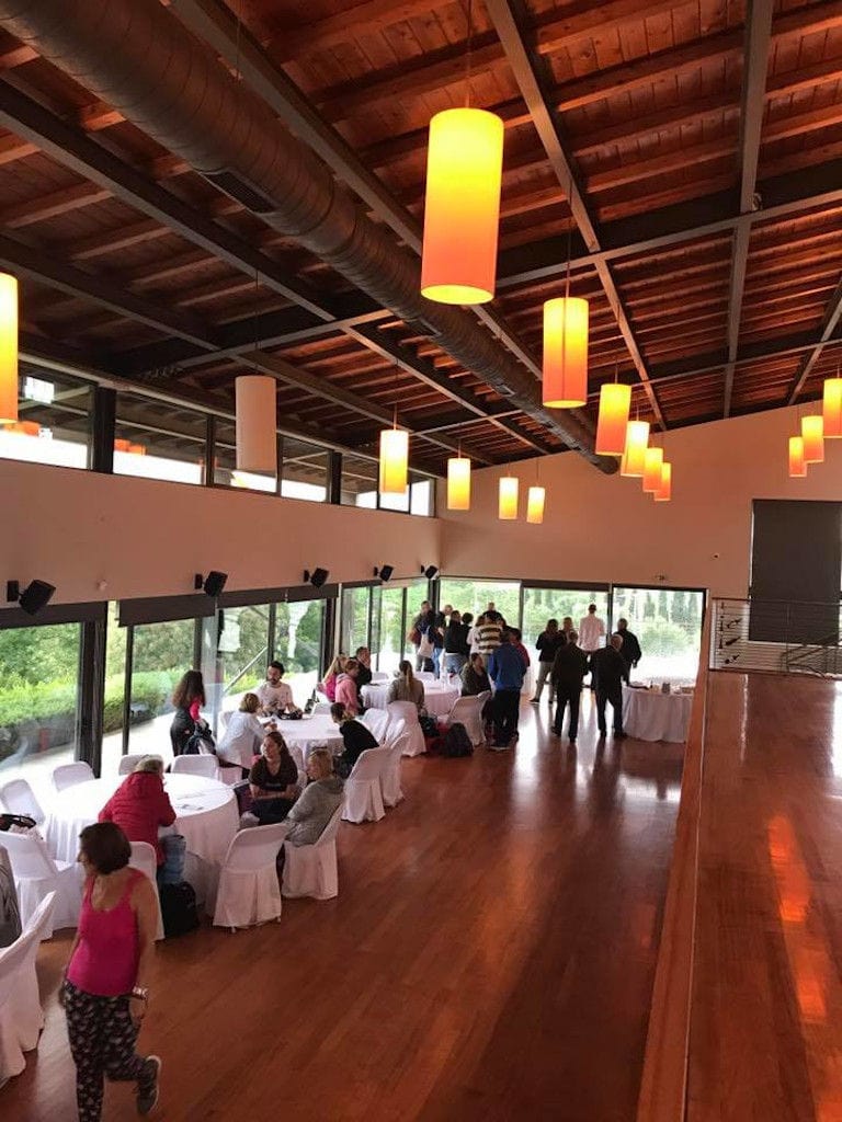 tourists drinking wines at illuminated Domaine Papagiannakos tasting room